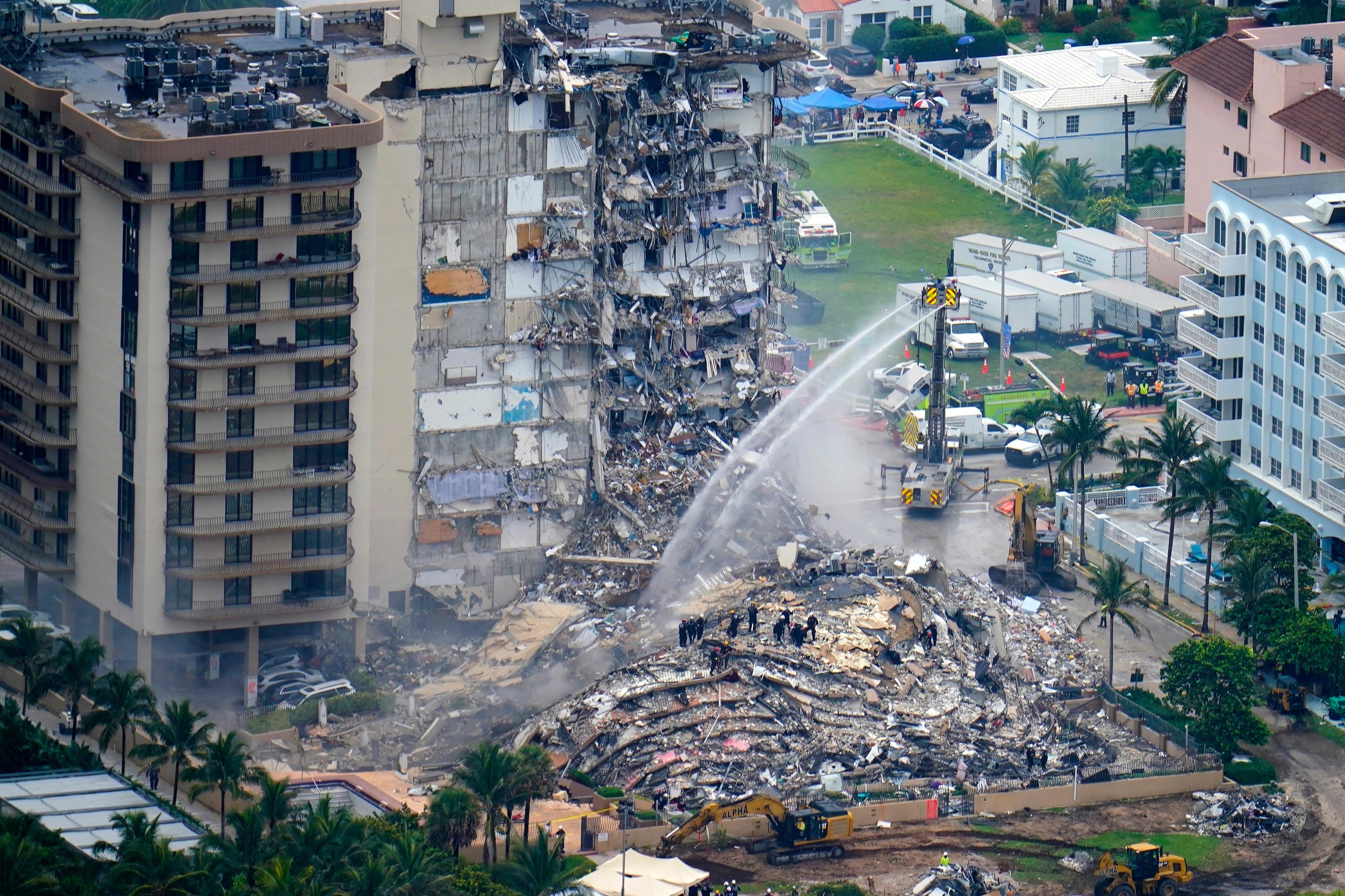 Rescue personnel work at the remains of the Champlain Towers South condo building, June 25, 2021, in Surfside, Florida