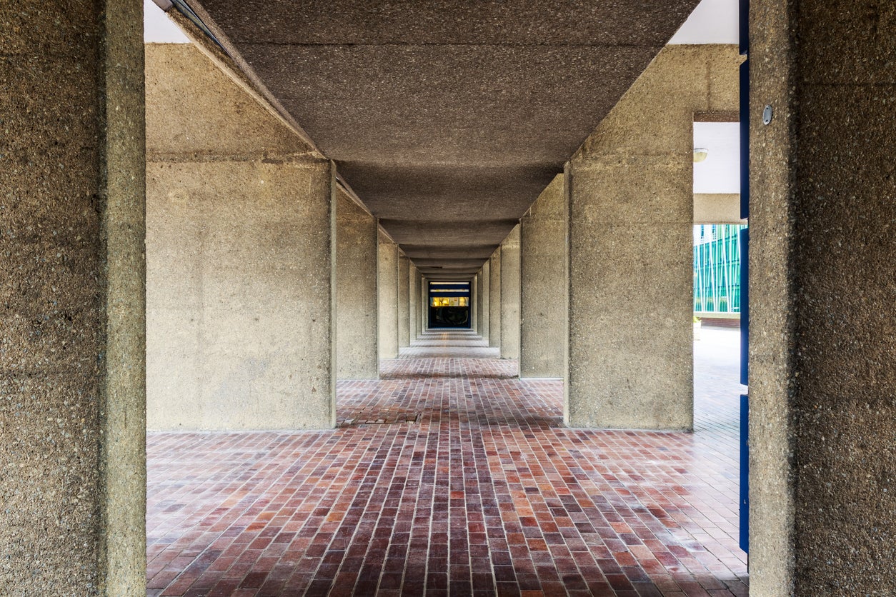 A walkway under the Brutalist architecture of the Barbican complex in London