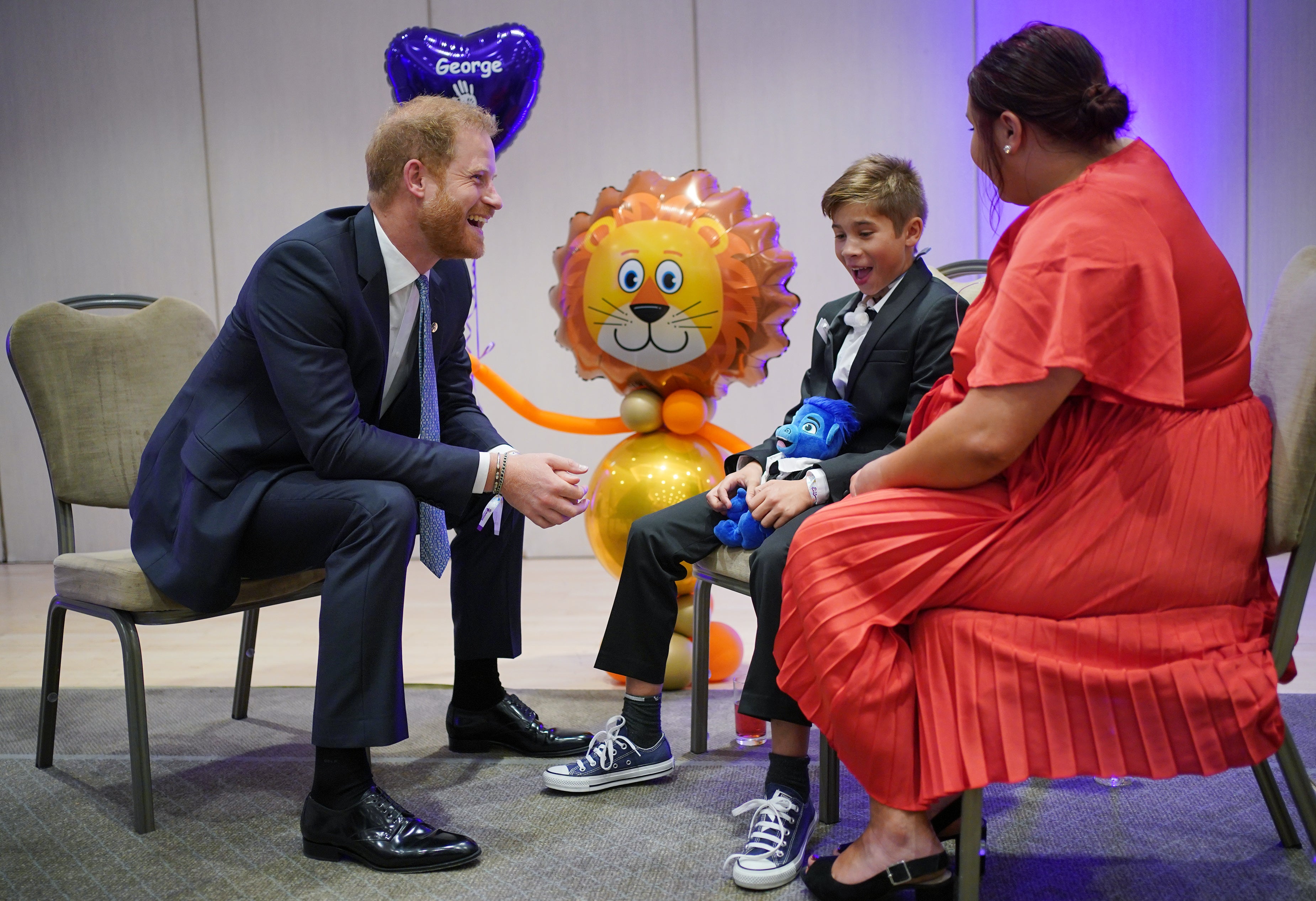 A solo Prince Harry greeted award winner George Hall with a fist-bump at the WellChild Awards