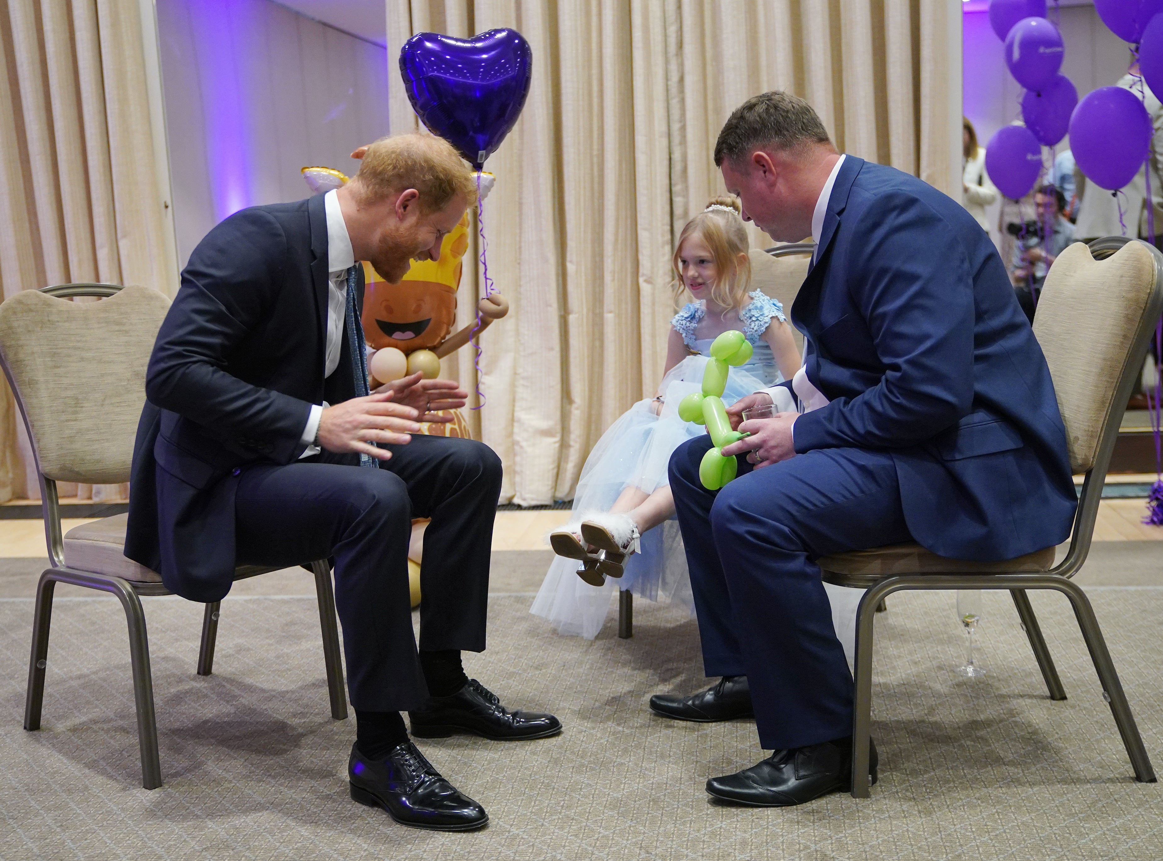 Prince Harry with Poppy and her father Daniel Higham at the WellChild Awards, where he took the opportunity to meet with many of the children present.