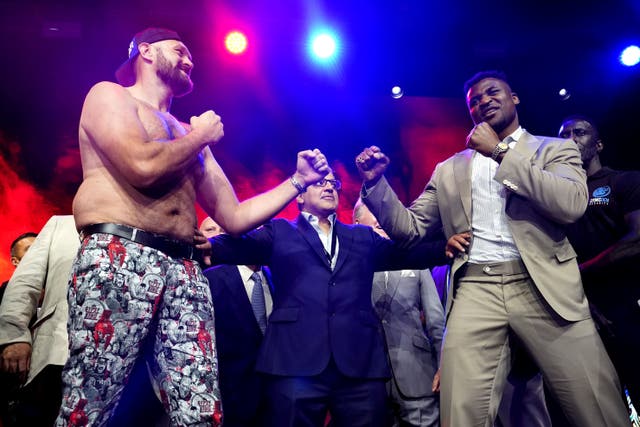 <p>Tyson Fury, left, and Francis Ngannou, right, will fight in October (James Manning/PA)</p>