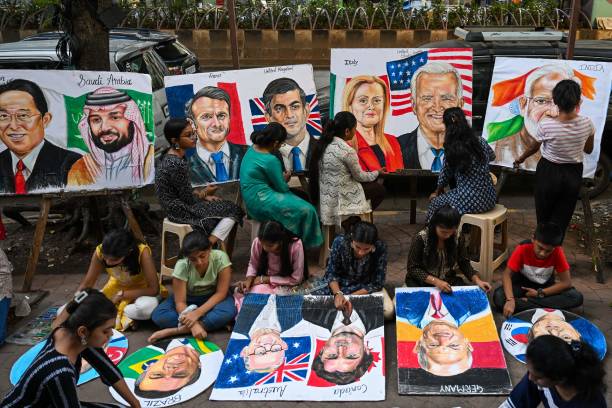 Students work on paintings of world leaders at an art school in Mumbai