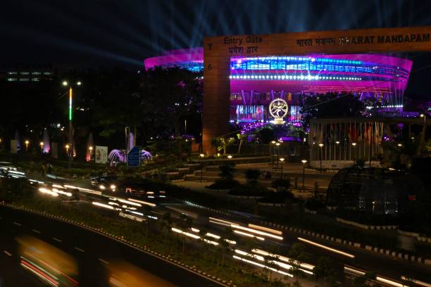 Vehicles drive along a street in front of the 27-feet tall bronze figurine statue 'Nataraja' installed at a G20 India summit venue in New Delhi