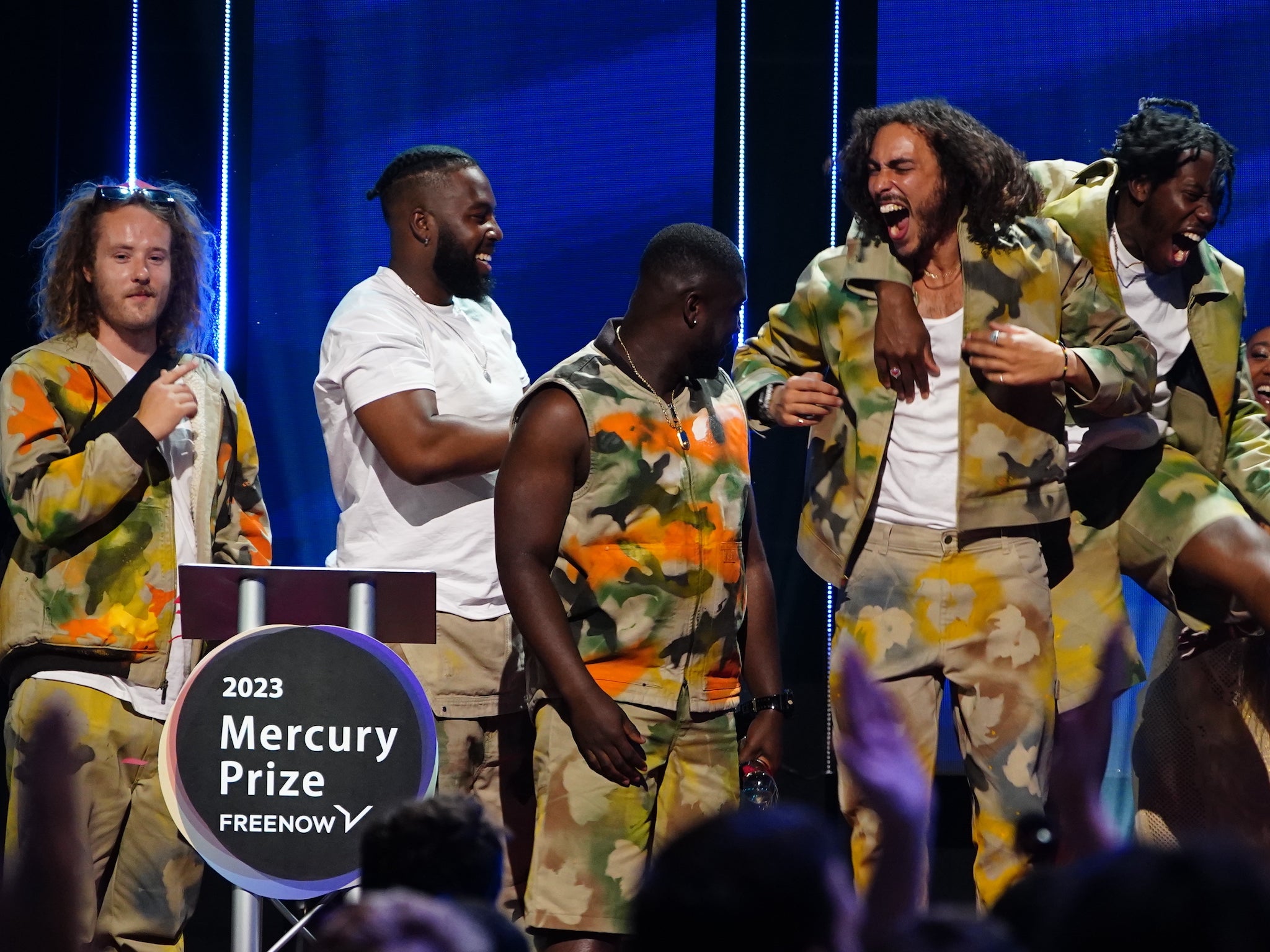 The group celebrate on stage after winning the 2023 Mercury Prize award
