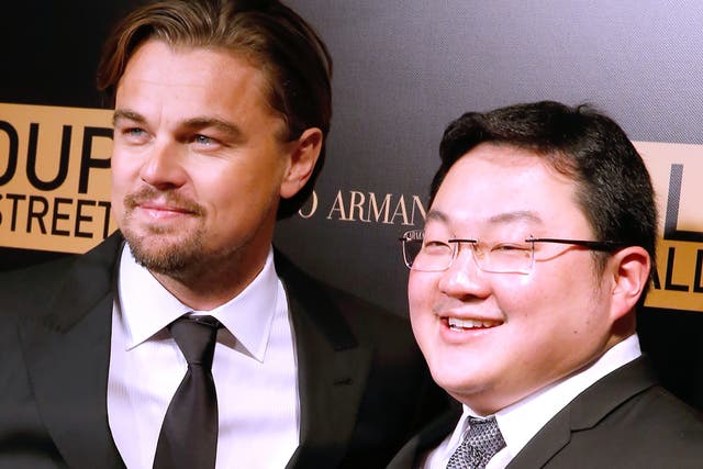 <p>International man of mystery: Jho Low poses with Leonardo DiCaprio at the French premiere of ‘The Wolf of Wall Street’ in 2013</p>