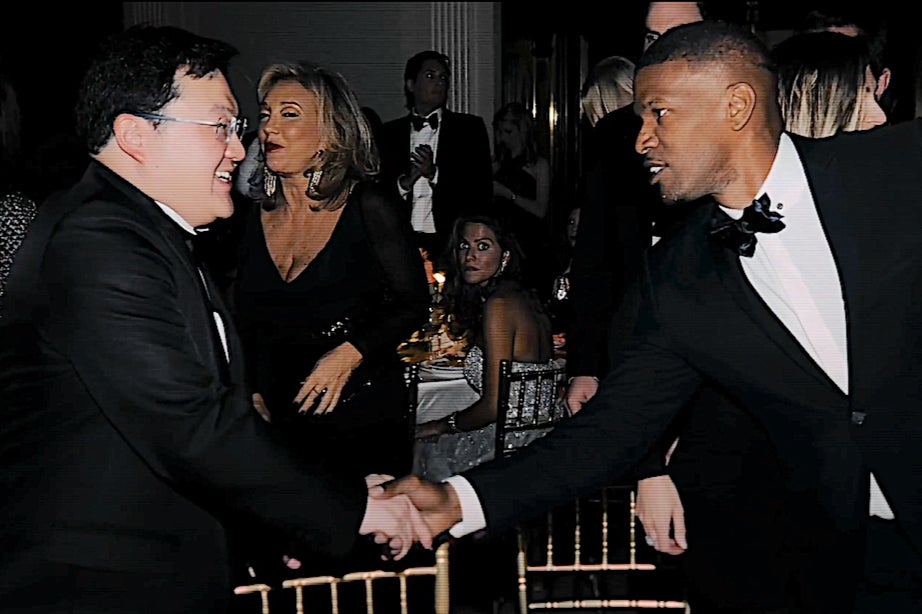 Life of the party: Jho Low shakes hands with Jamie Foxx at a Hollywood event
