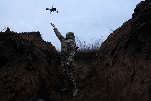 <p>A Ukrainian solider with a commercial drone </p>