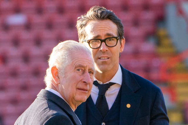 <p>King Charles III speaks with co-owner of Wrexham AFC Ryan Reynolds during a visit to Wrexham Association Football Club (AFC)</p>