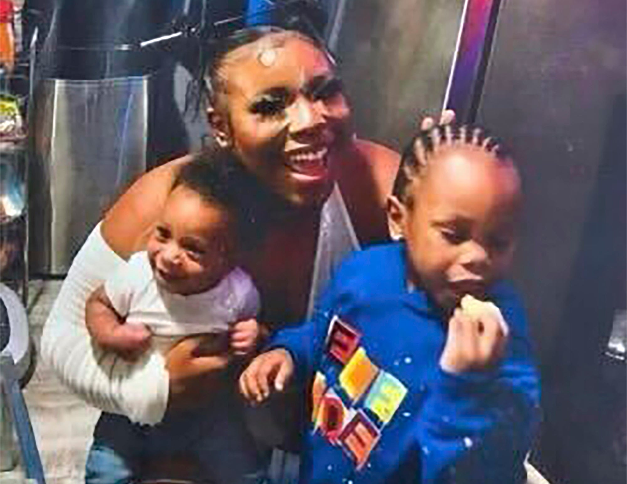 In this photo released by the Young Family via their family attorney, Ta'Kiya Young is pictured with her sons, Ja'Kobie, right, and Ja'Kenlie, left