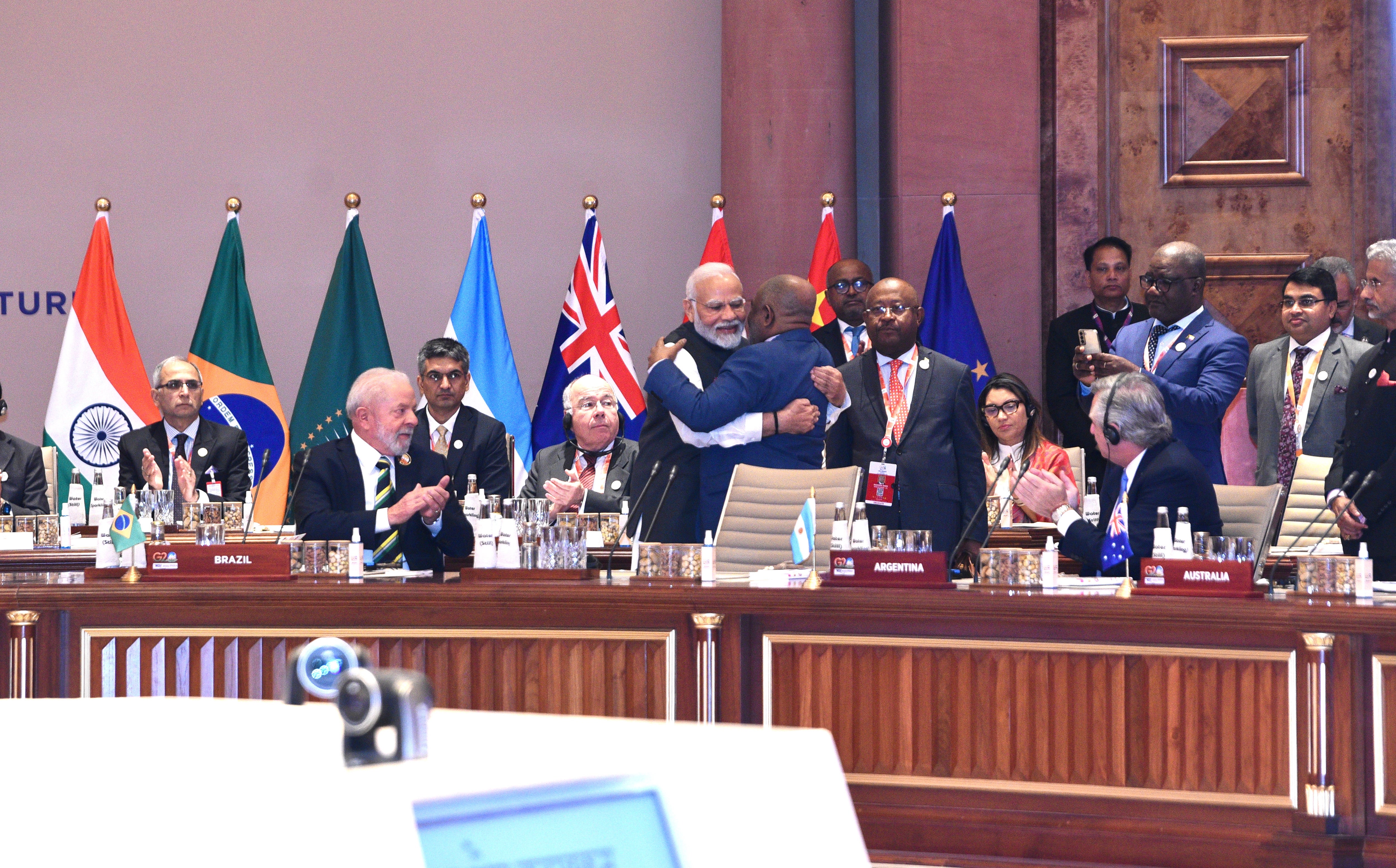 Modi embracing Comoros president and African Union chair Azali Assoumani (C-R) after welcoming him to take up a permanent chair at the G20 table