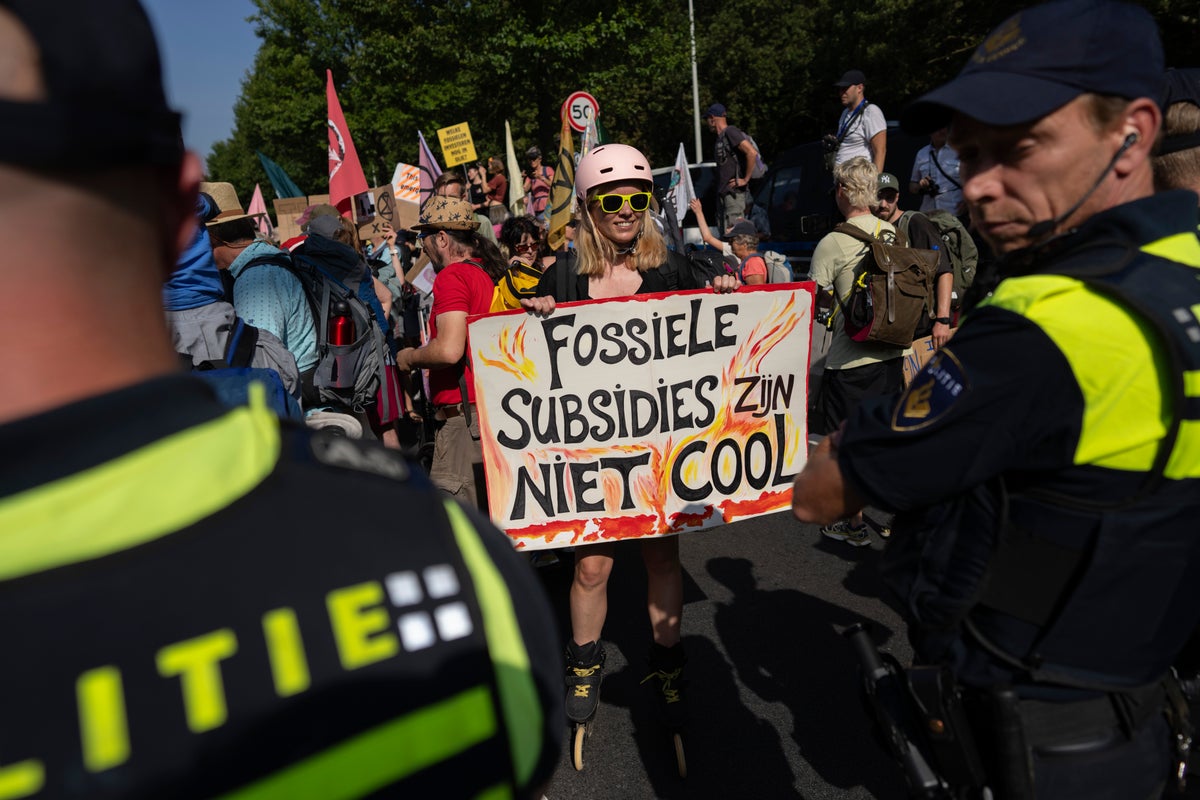 Climate protesters have blocked a Dutch highway to demand an end to big subsidies for fossil fuels