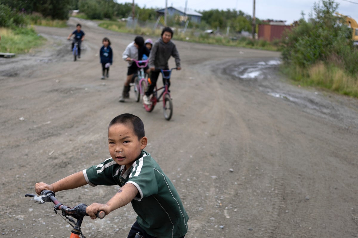 Children in remote Alaska aim for carnival prizes, show off their winnings and launch fireworks