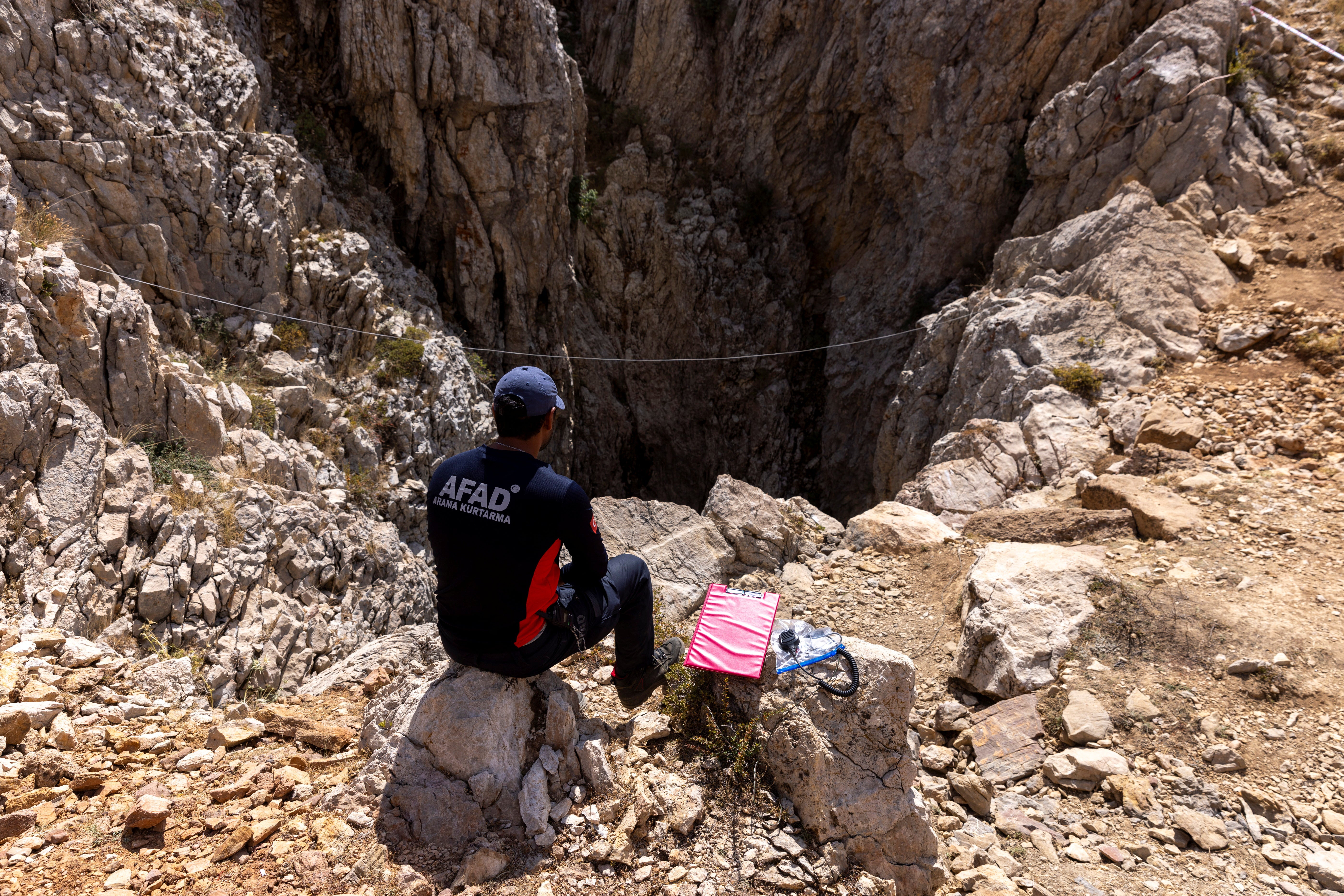 A rescuer is seen at the entrance of Morca Cave