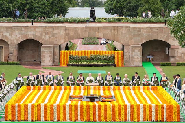 <p>India’s prime minister Narendra Modi, centre, paying homage with other world leaders at Mahatma Gandhi’s memorial in Raj Ghat</p>