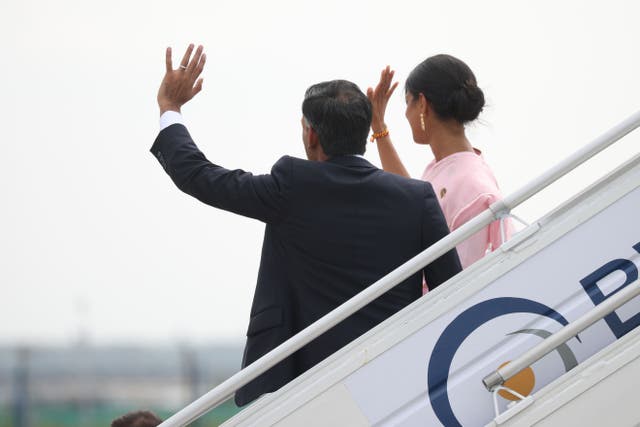 Prime Minister Rishi Sunak and his wife Akshata Murty board a plane after the G20 Summit in New Delhi (Dan Kitwood/PA)
