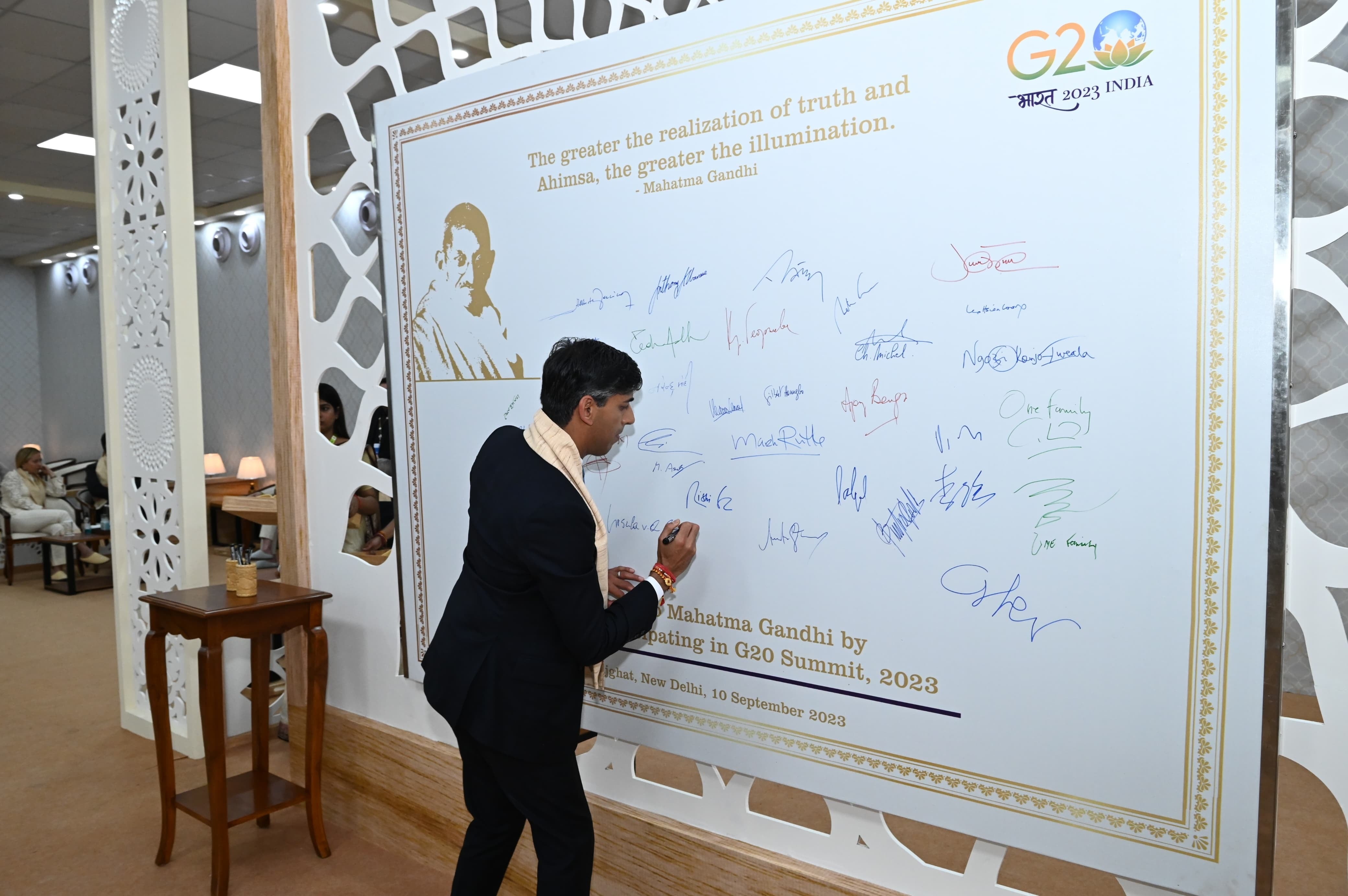 British prime minister Rishi Sunak signs the ‘Peace Wall’ at the Raj Ghat