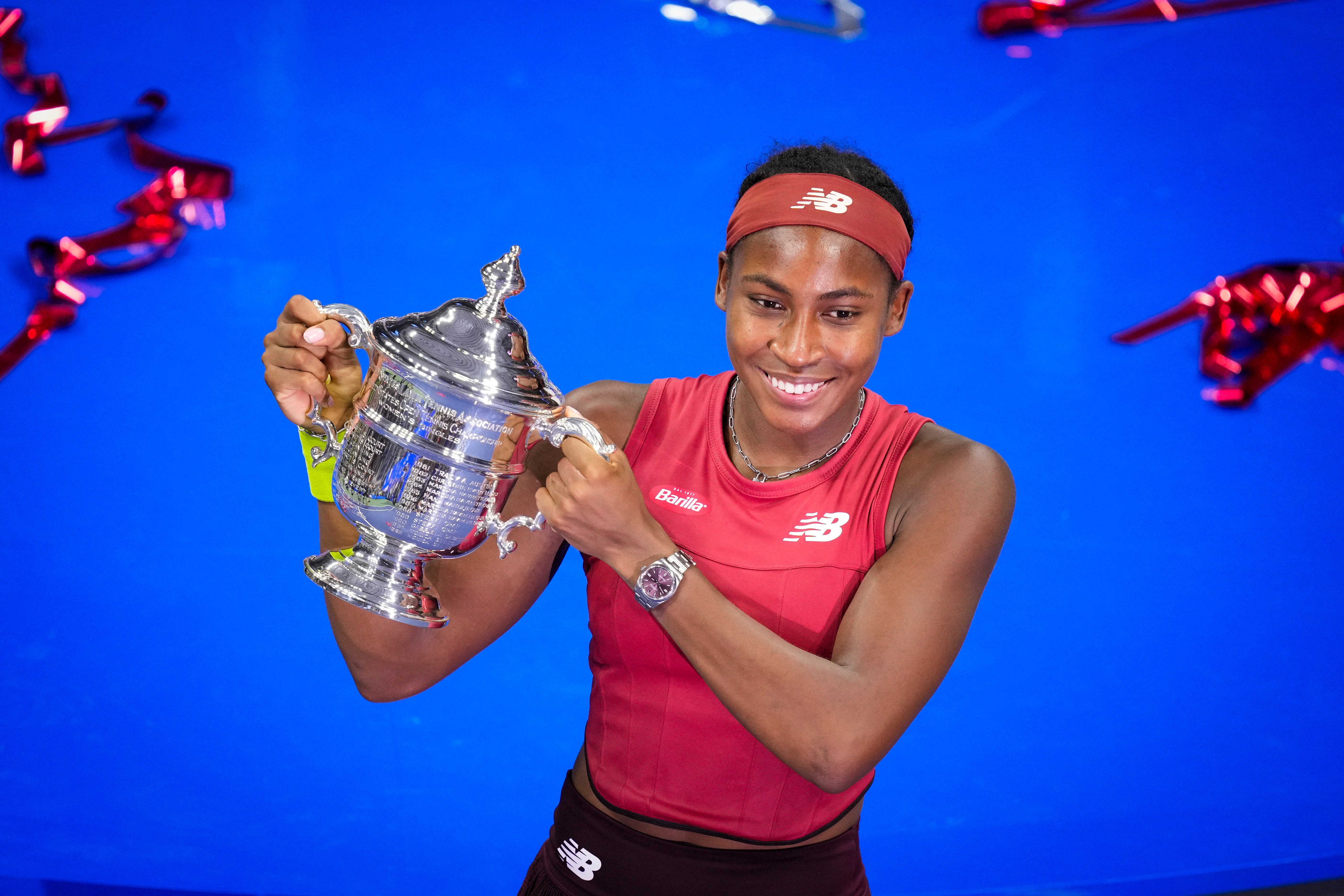 Coco Gauff poses with the US Open trophy (John Minchillo/AP)