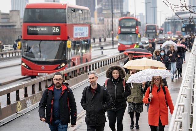 Commuters cross Waterloo Bridge in London (Dominic Lipinski/PA)