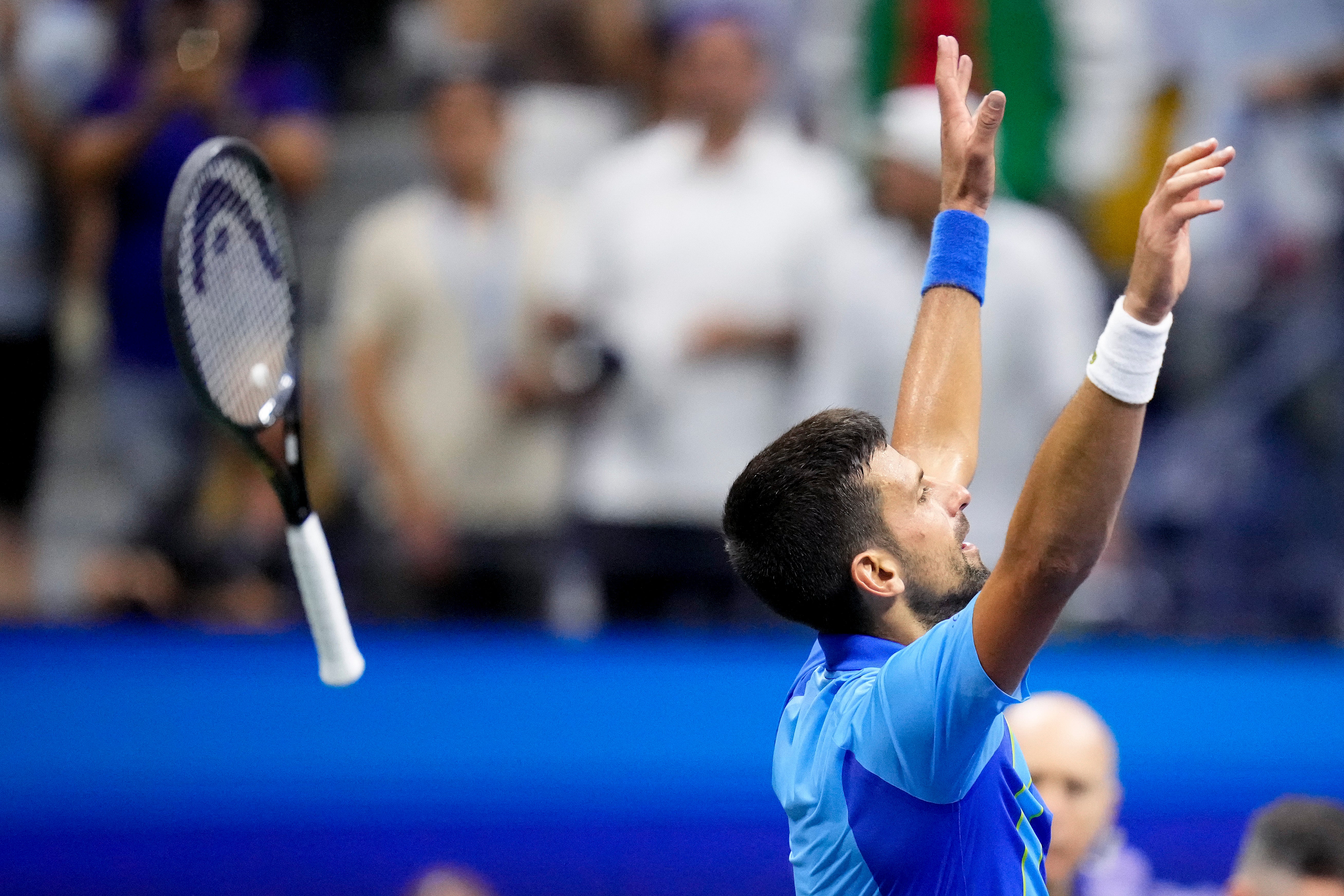 Novak Djokovic, of Serbia, tosses his racket after defeating Daniil Medvedev