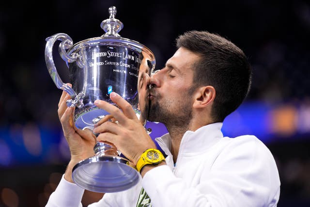 <p>Novak Djokovic, of Serbia, kisses the championship trophy after defeating Daniil Medvedev, of Russia</p>