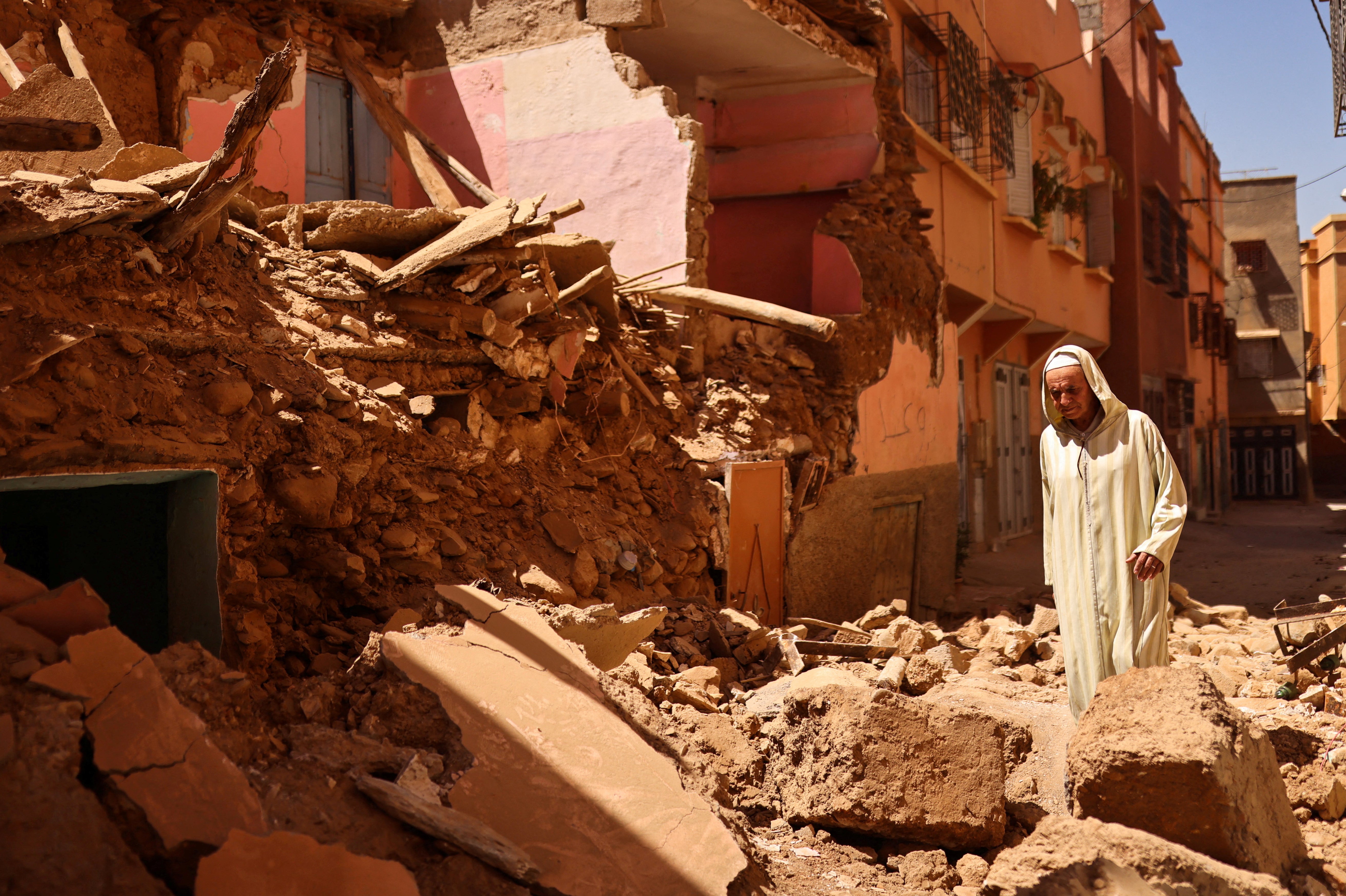 Mohamed Sebbagh, 66, stands in front of his destroyed house