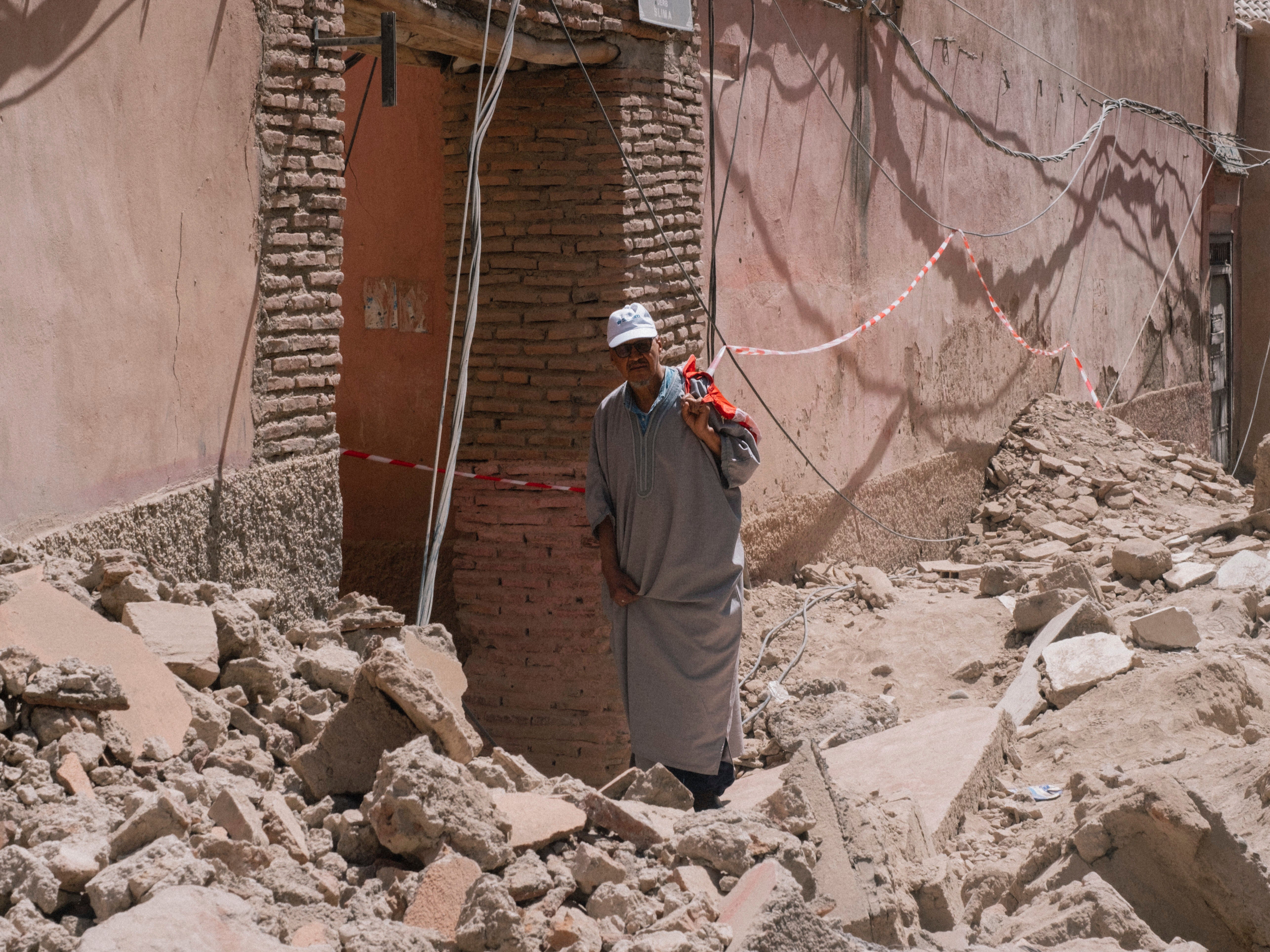 A man inspects damage caused by the earthquake as he walks in the old Medina of Marrakech
