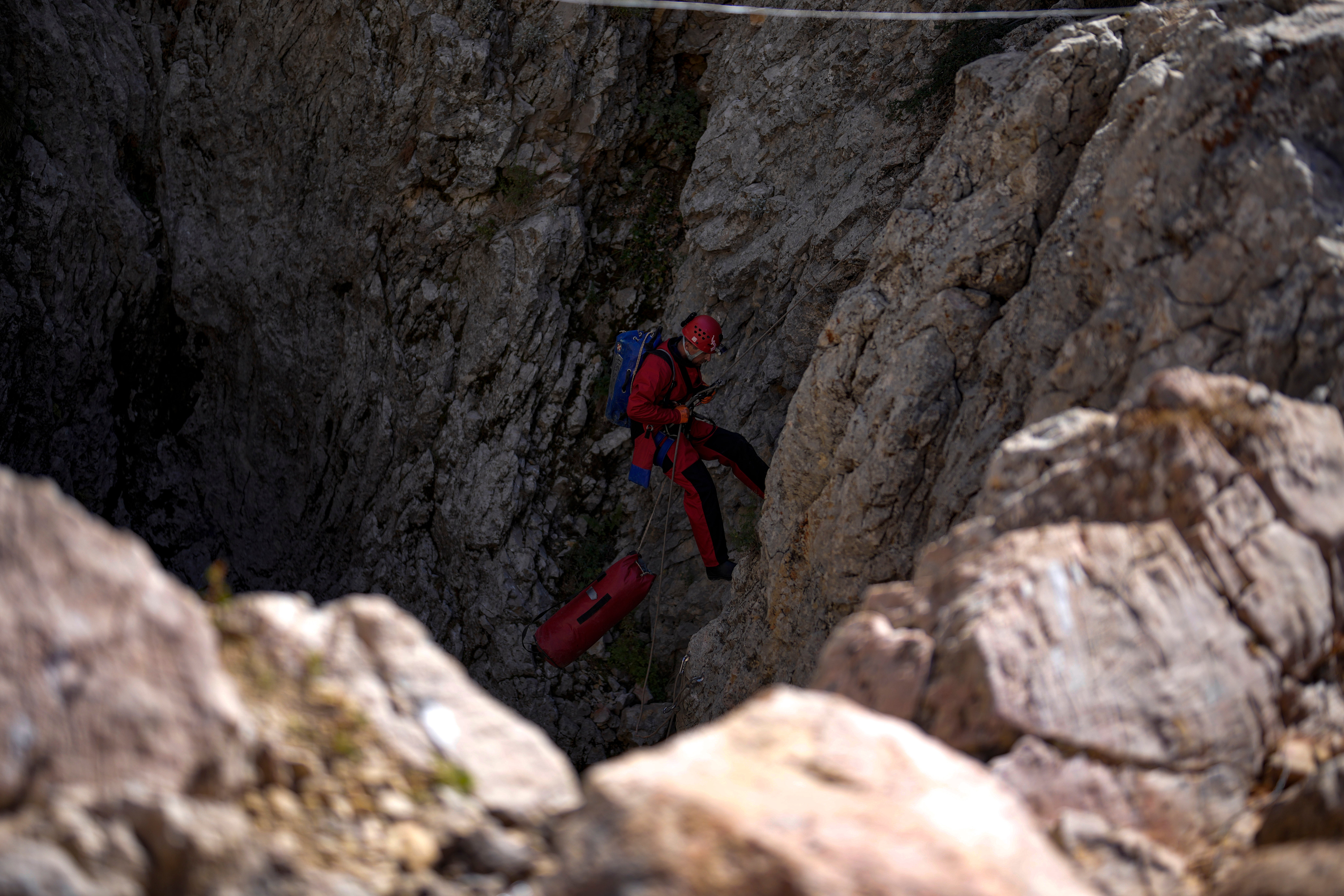 A European Cave Rescue Association member goes down into the Morca cave during Dickey’s rescue