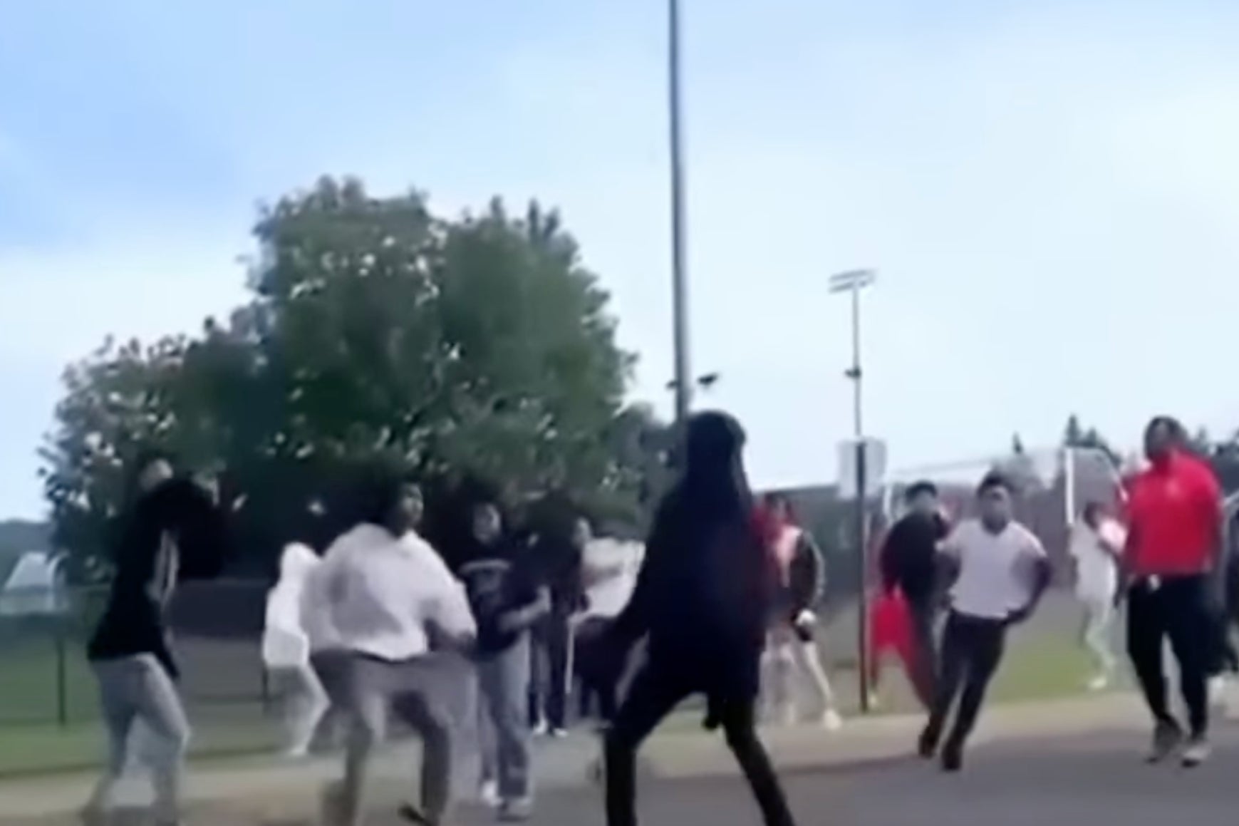 <p>A security guard was shot while trying to break up a fight (pictured) at a high school football game in Utica, New York</p>