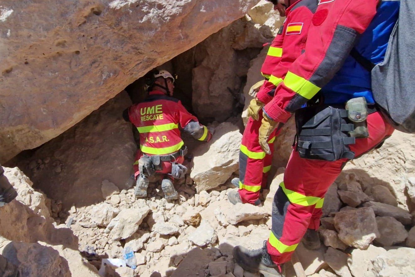 Members of Spain’s Military Emergency Unit (UME) work to reach potential victims in the village of Anougal
