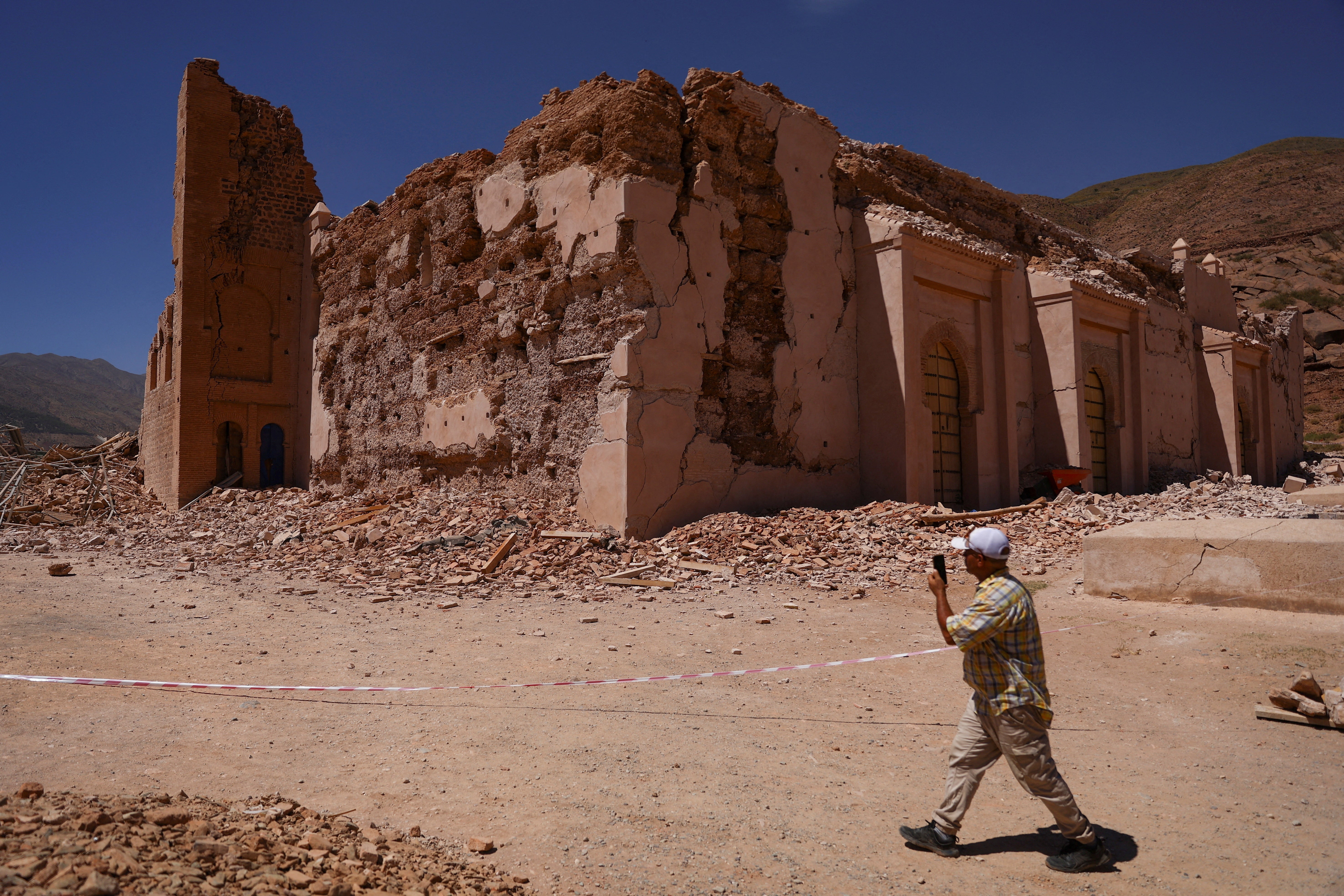 A man walks near Tinmel Mosque, which was damaged by the deadly earthquake, in Tinmel, Morocco