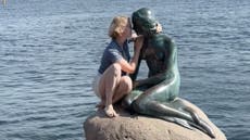 Tourist booed as she climbs Copenhagen’s Little Mermaid statue despite warnings