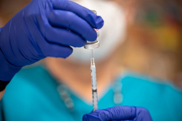 <p>A nurse fills up a syringe with the Moderna COVID-19 vaccine at a vaccination site at a senior centre on March 29, 2021 in San Antonio, Texas. </p>