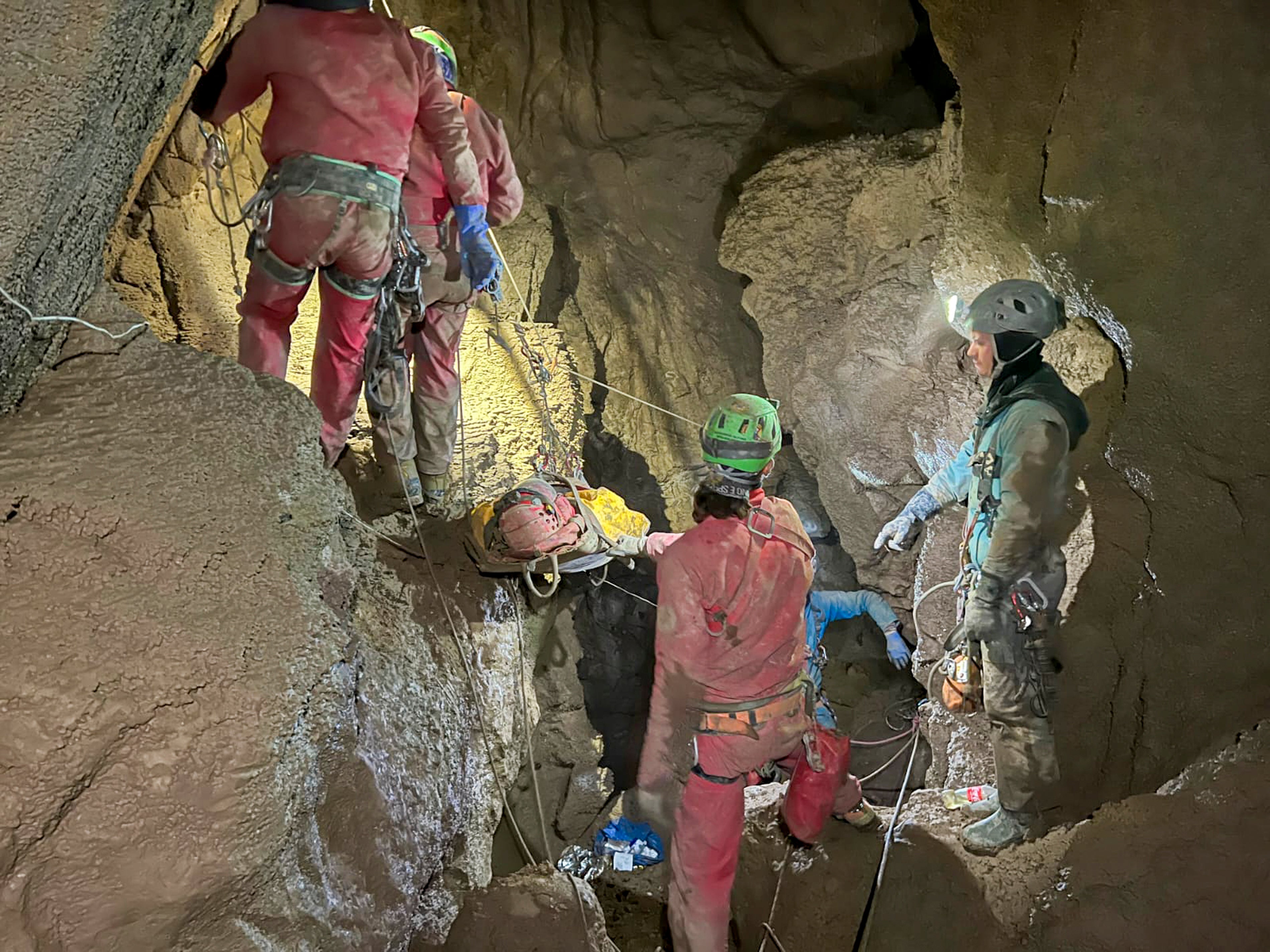 Members of the CNSAS, Italian alpine and speleological rescuers carry a stretcher holding American researcher Mark Dickey during a rescue operation in the Morca cave, near Anamur
