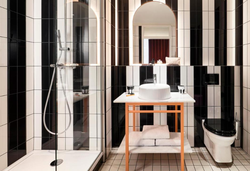 With a more-is-more style, bathrooms come in zebra-stripe tiles