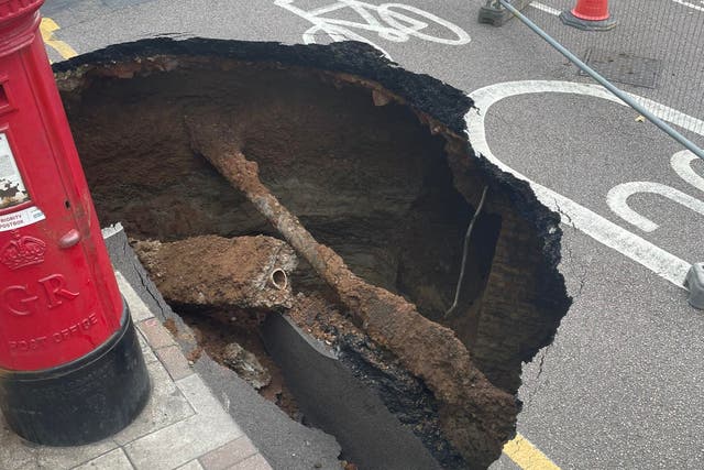 <p>Residents on Dunvegan Road in Eltham, Greenwich, London awoke to discover a sinkhole the size of a small car opened up overnight on September 12</p>