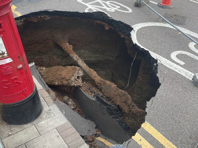 <p>Residents on Dunvegan Road in Eltham, Greenwich, London awoke to discover a sinkhole the size of a small car opened up overnight on September 12</p>