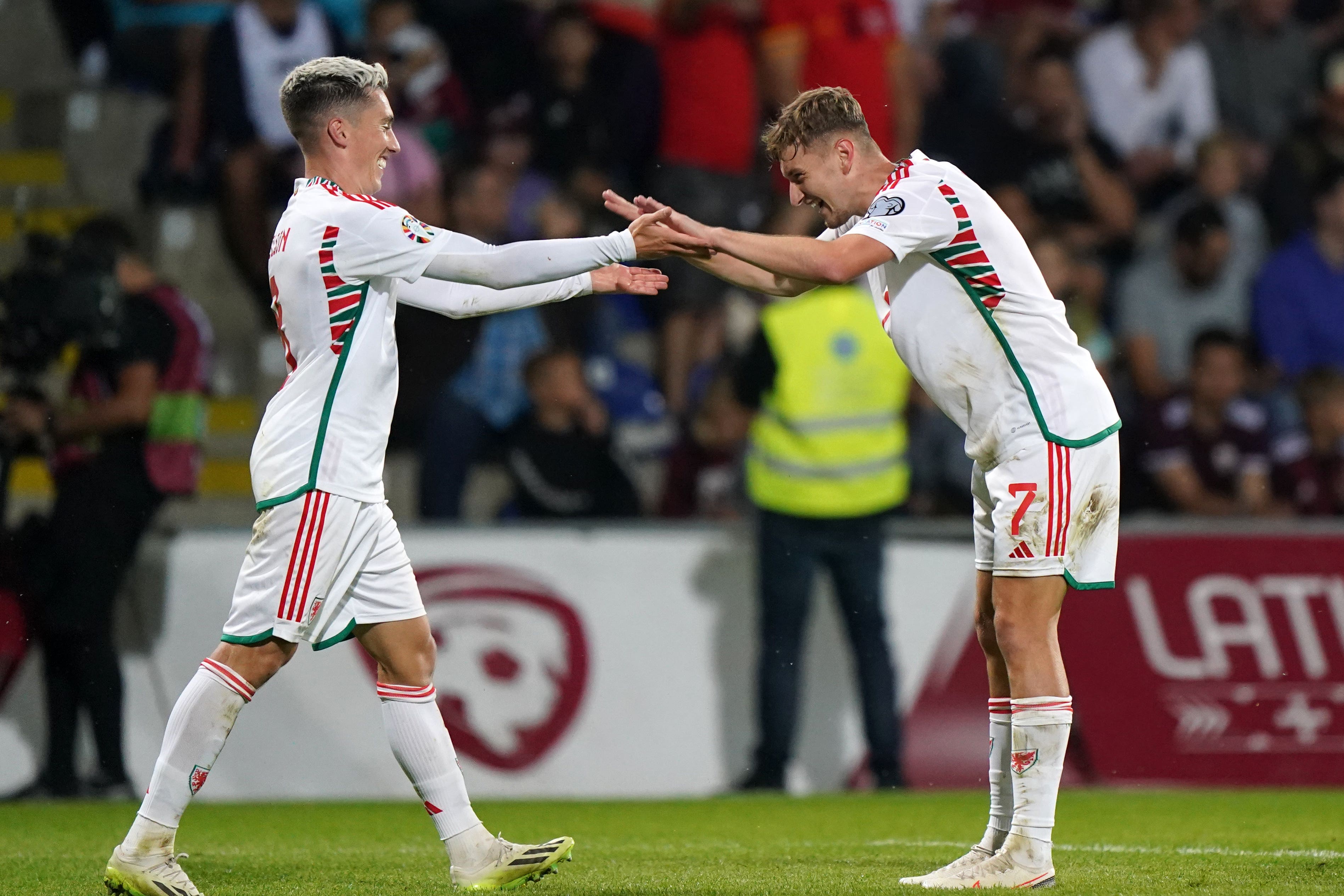 David Brooks (right) celebrates scoring Wales’ second goal with Harry Wilson against Latvia in Riga (Tim Goode/PA)
