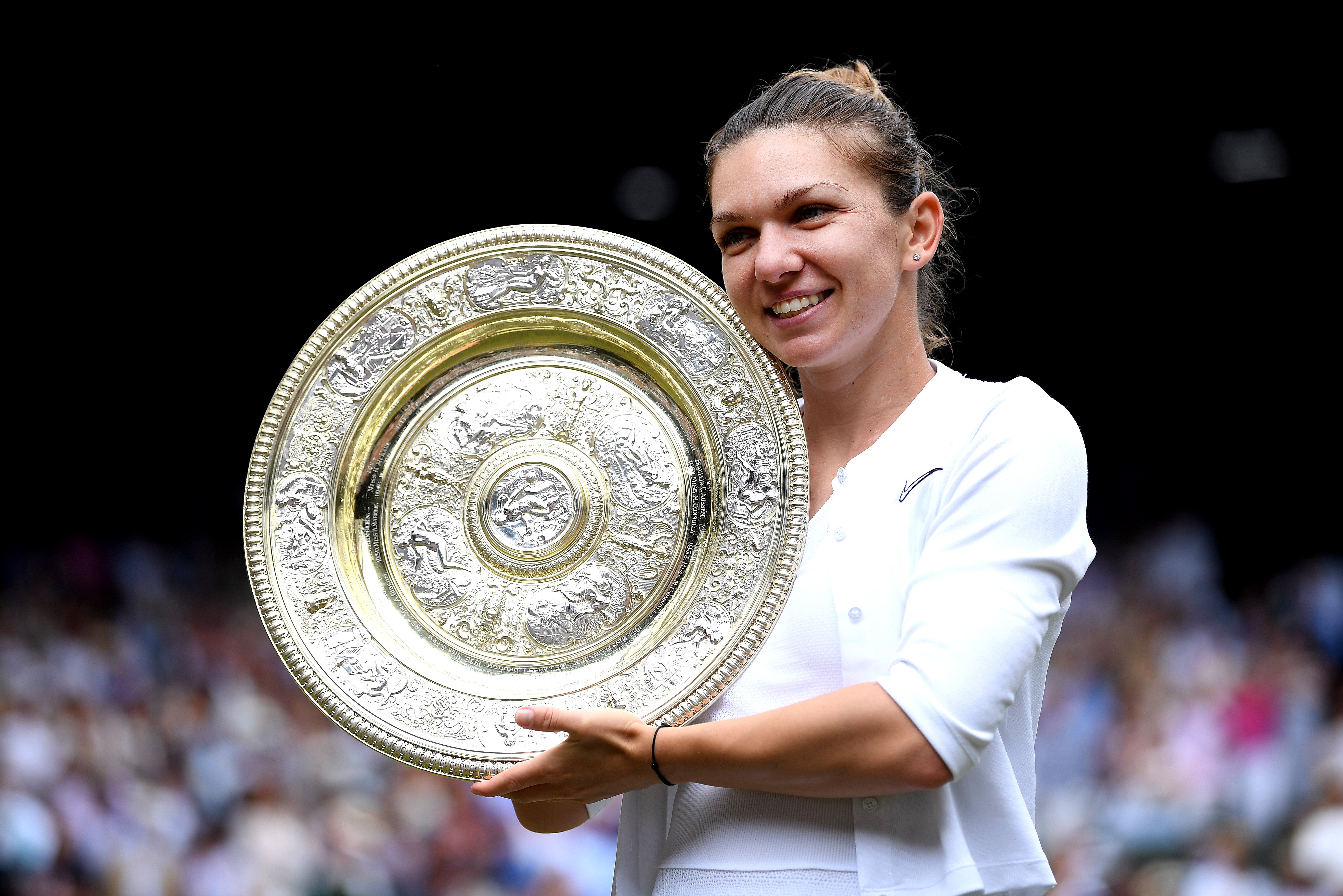 <p>Simona Halep poses with the Wimbledon women’s singles trophy</p>