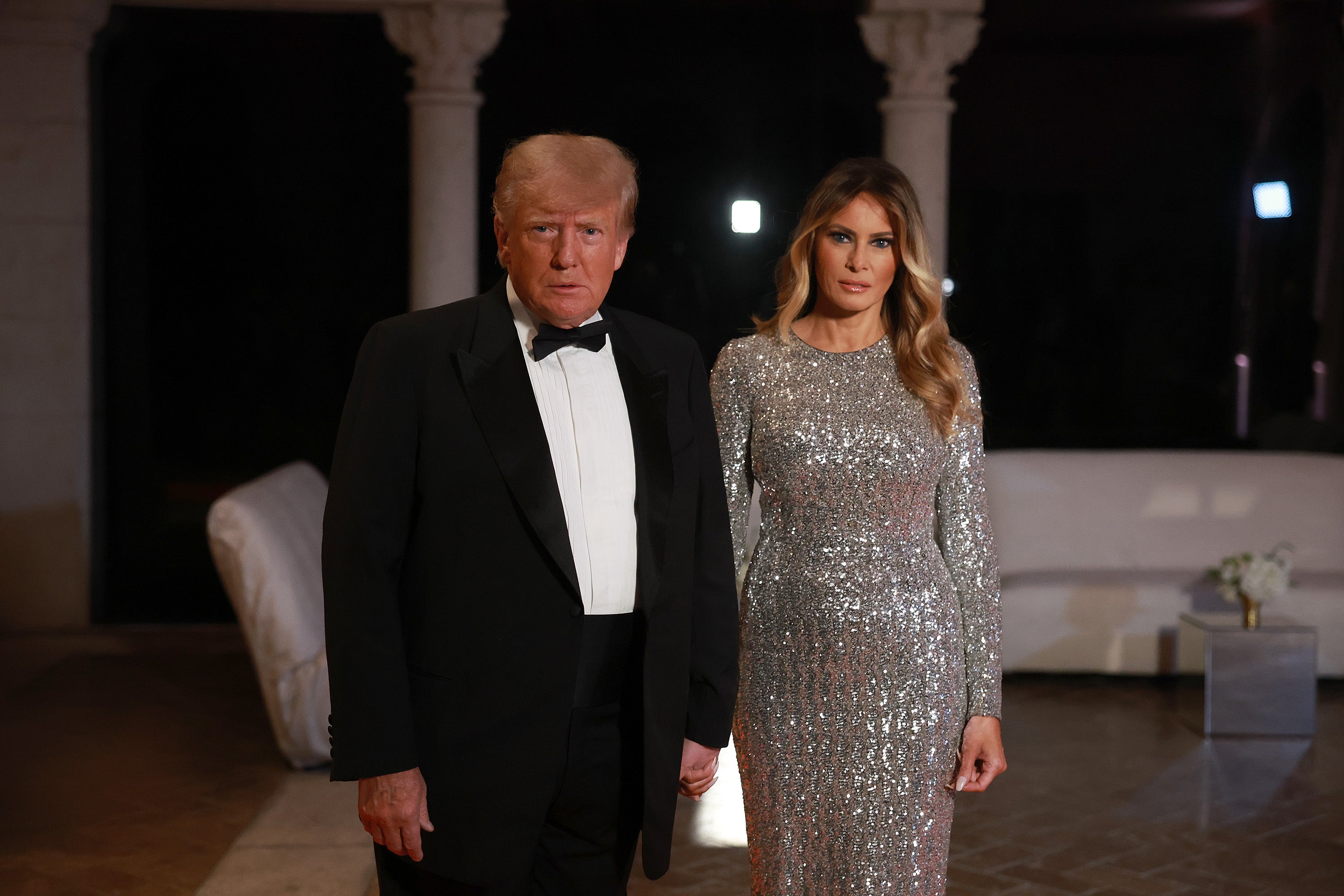 Former US President Donald Trump and former first lady Melania Trump arrive for a New Years event at his Mar-a-Lago home on December 31, 2022 in Palm Beach, Florida.