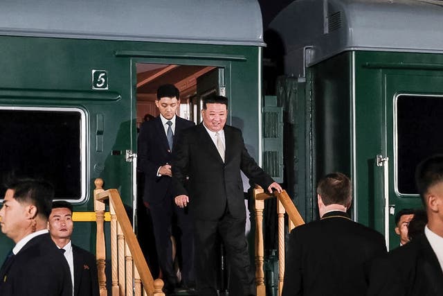 <p>North Korea’s leader Kim Jong-un, center, steps down from his train after crossing the border to Russia at Khasan</p>