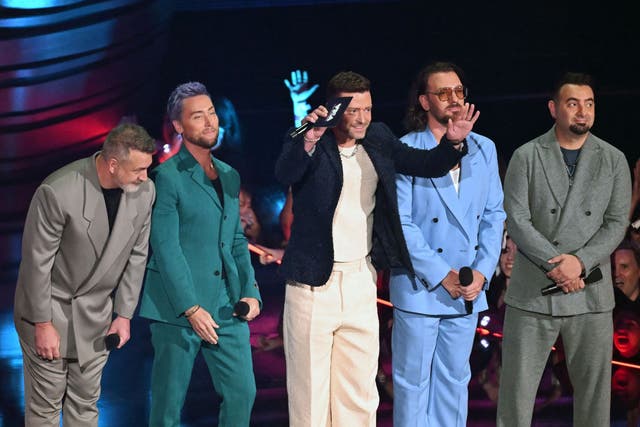 <p>(From left) Joey Fatone, Lance Bass, Justin Timberlake, JC Chasez and Chris Kirkpatrick of former boy band NSYNC speak onstage during the MTV Video Music Awards</p>