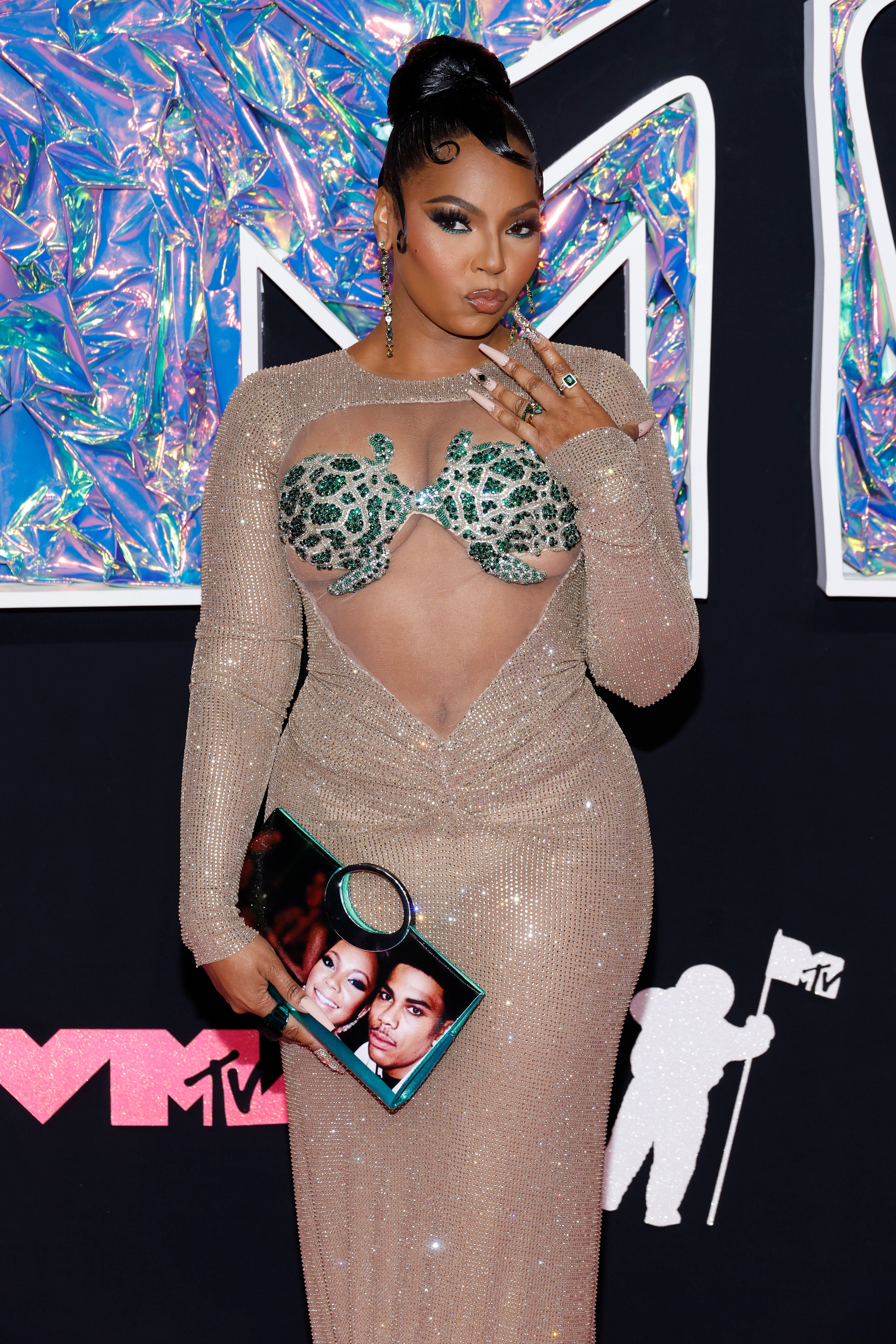Ashanti confirms she and Nelly are back together as she holds purse with their photo at 2023 MTV VMAs The Independent photo