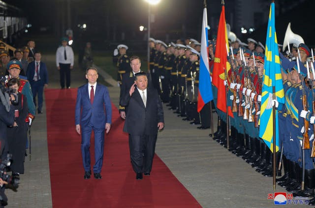 <p>North Korea’s leader Kim Jong-un, centre, attends a welcome ceremony after crossing the border to Russia at Khasan</p>