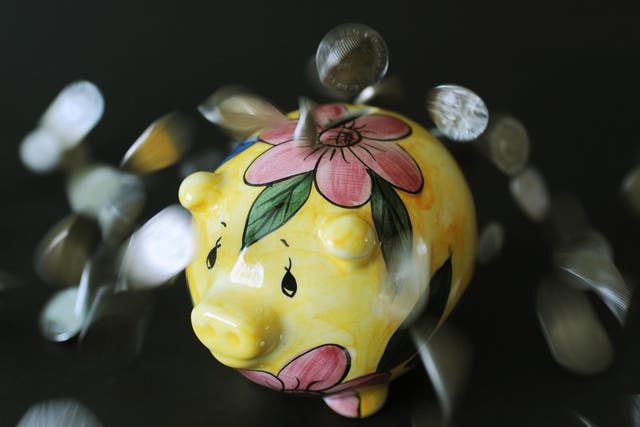 <p>A piggy bank with coins (Nick Ansell/PA)</p>
