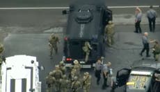 Pennsylvania police pose with captured Danelo Cavalcante after he led them on two-week chase