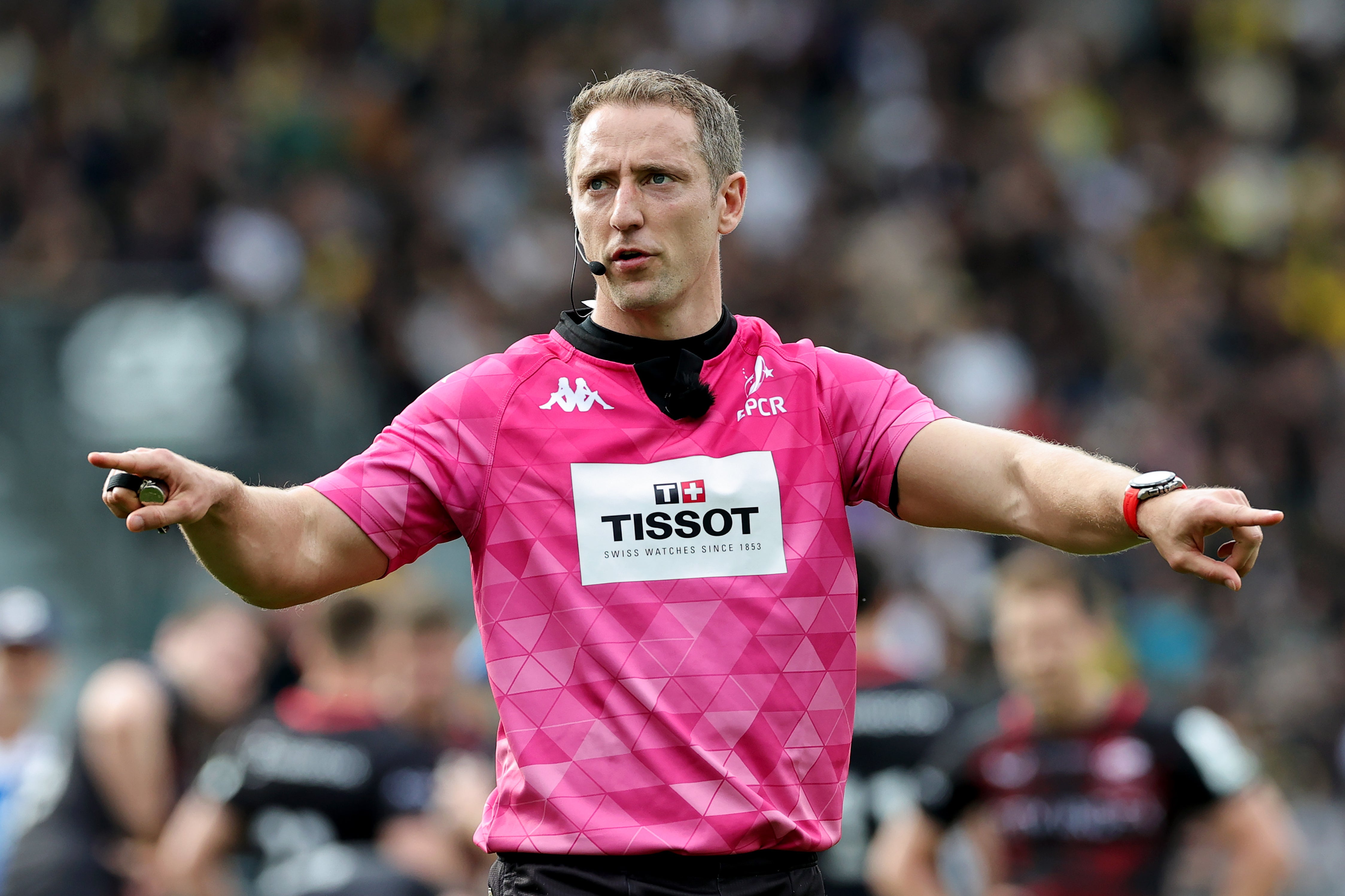 Referee Andrew Brace signals a referral to the TMO