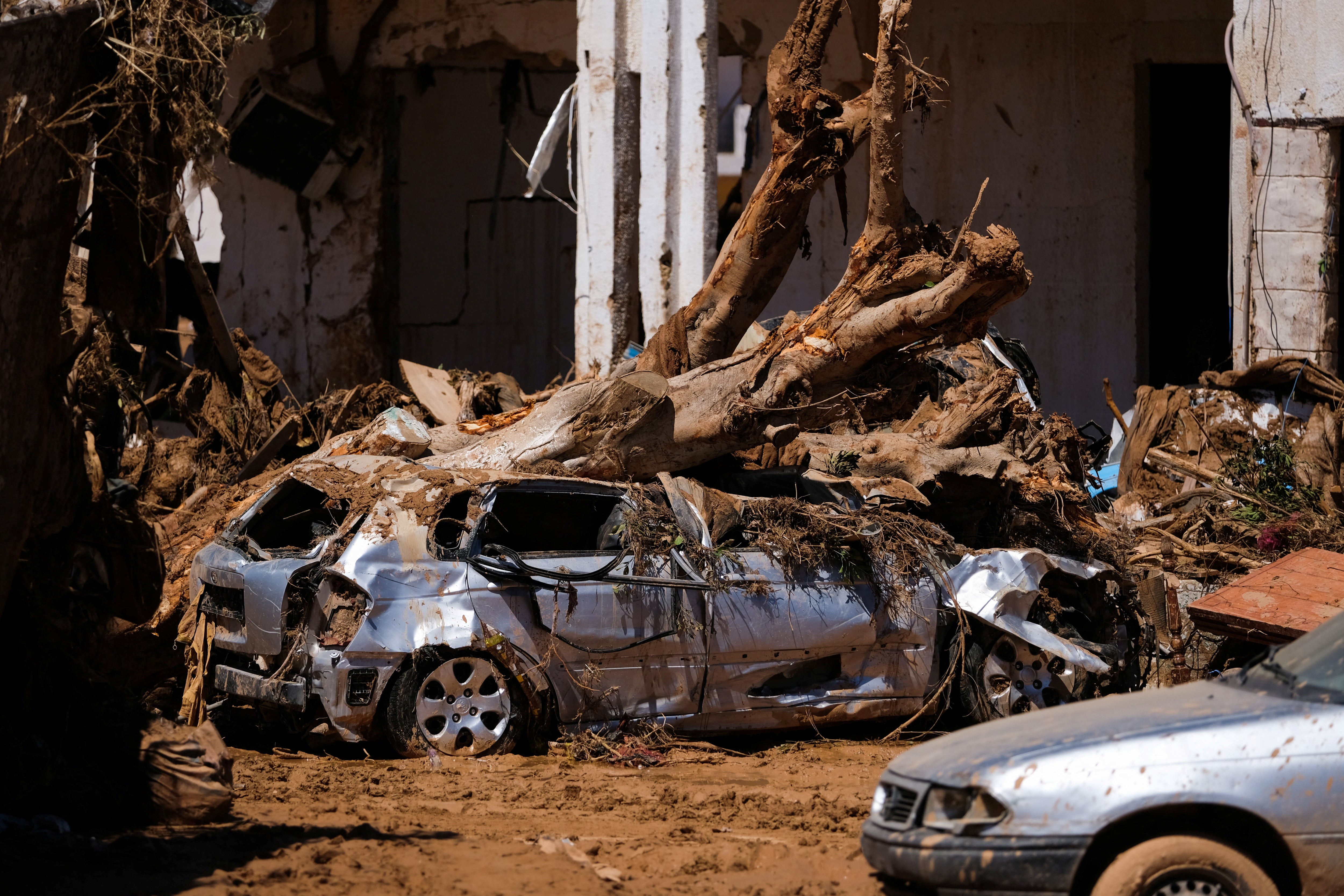 Flood-damaged cars and homes in the Libyan city of Derna