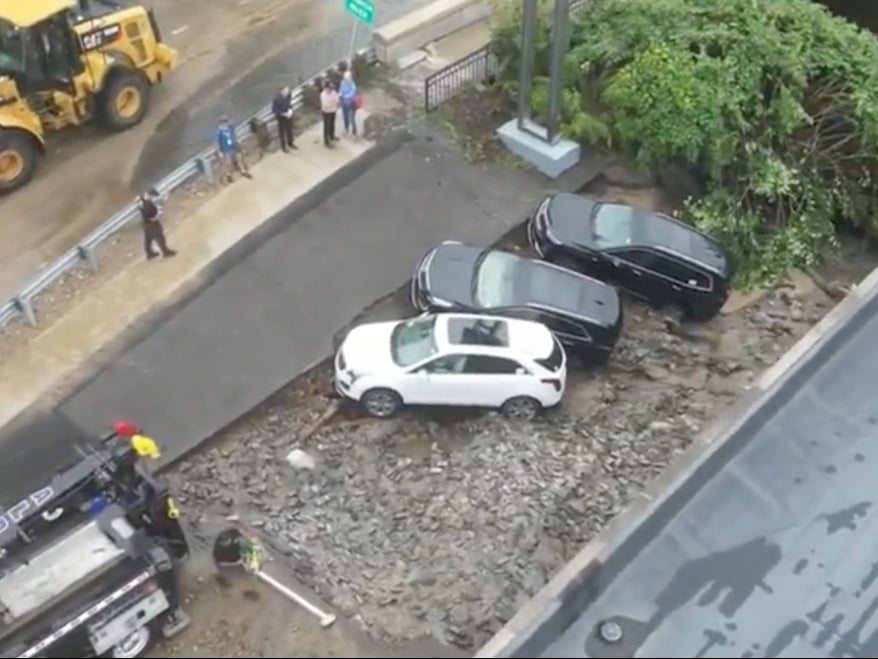 A trio of cars caught on the edge of a sinkhole that opened up in Leominster, Massachusetts after heavy rains