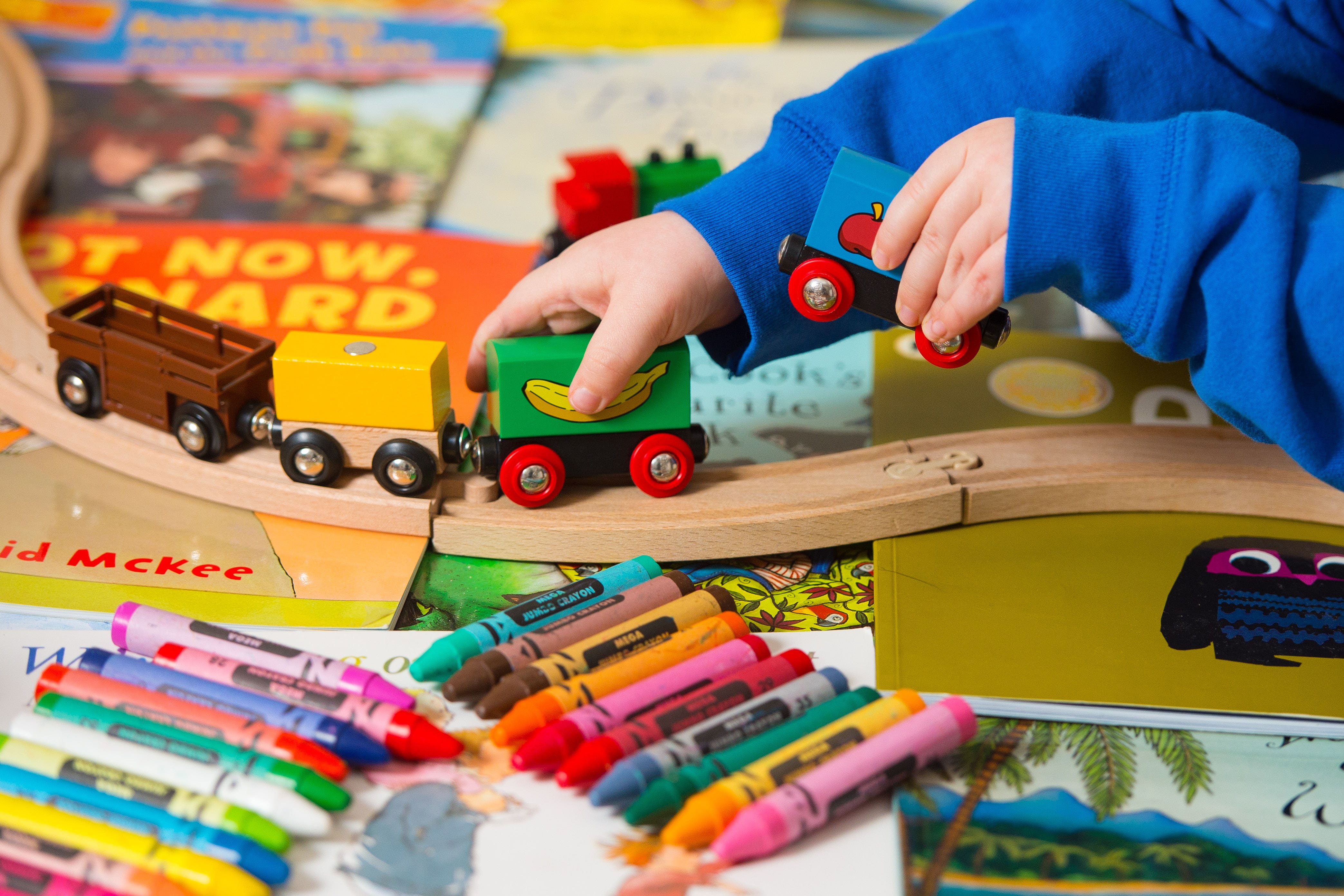 A toddler playing with a selection of children’s toys (Dominic Lipinski/PA)