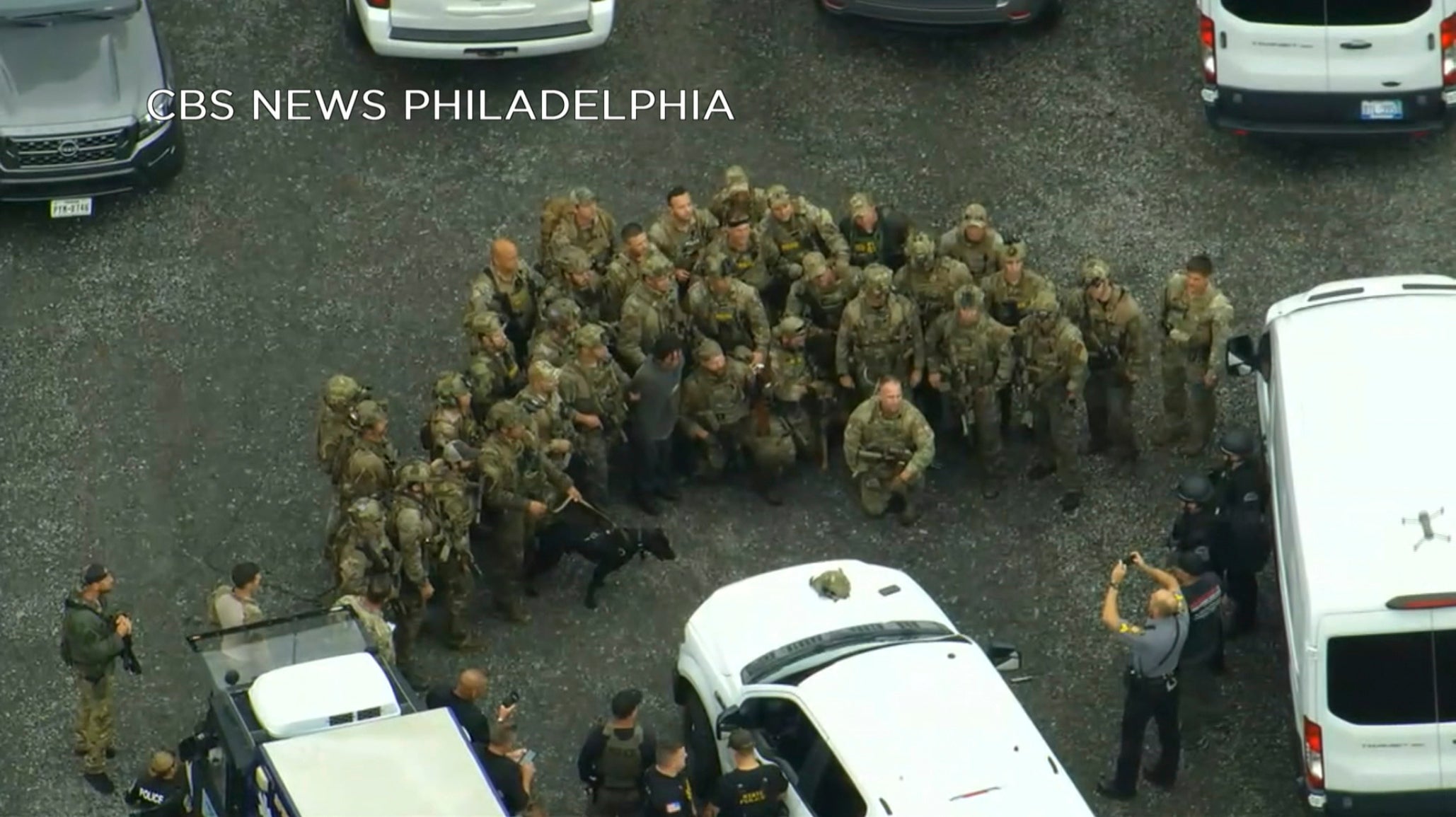 Officers take a group photo with captured Danelo Cavalcante